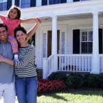 Happy Family in Front of House