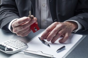 Man selling a home with keys in hand