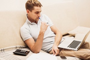 man working from couch